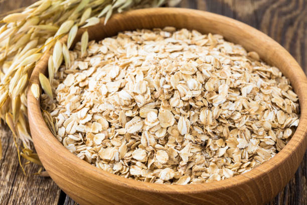 istock Rolled oat flakes in a wooden bowl 682763282