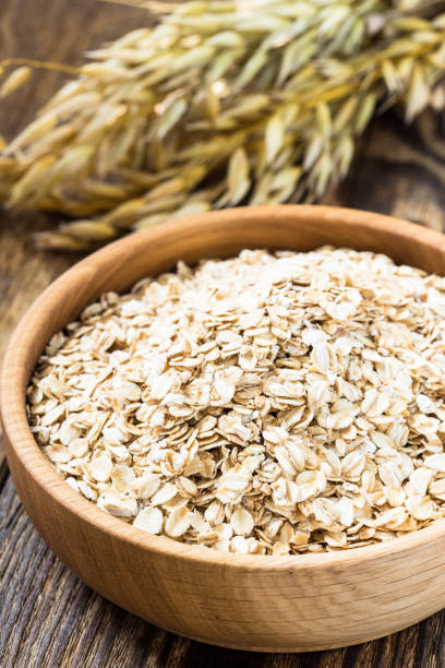 istock Rolled oat flakes in a wooden bowl 682763456
