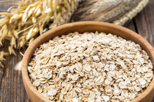 istock Rolled oat flakes in a wooden bowl 682764006