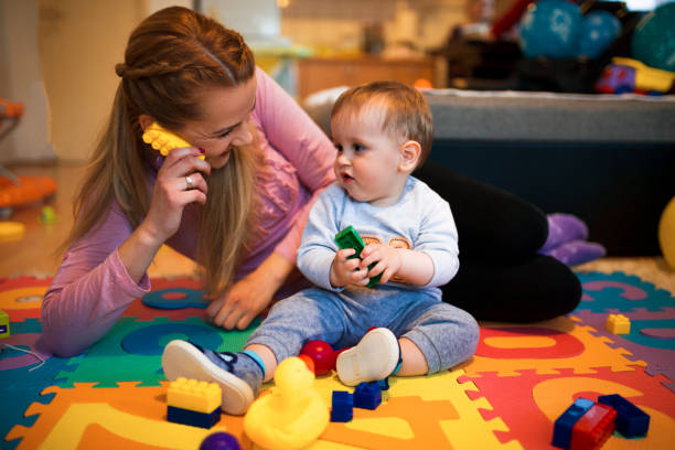istock Mother and baby playing with toys 682772664