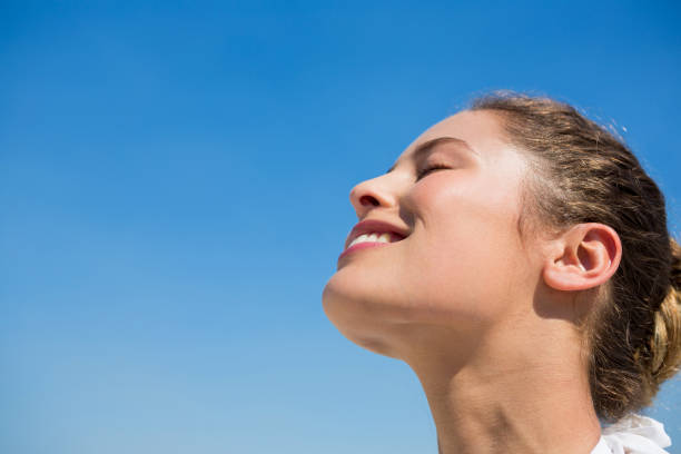 istock Low angle view of smiling woman with head back 682772790