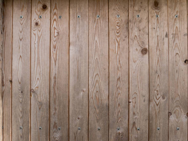 istock Wooden brown planks with metallic rivets background 682772948