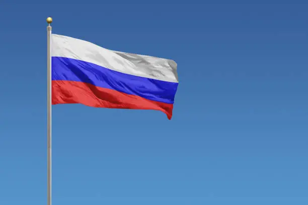 Flag of Russia in front of a clear blue sky