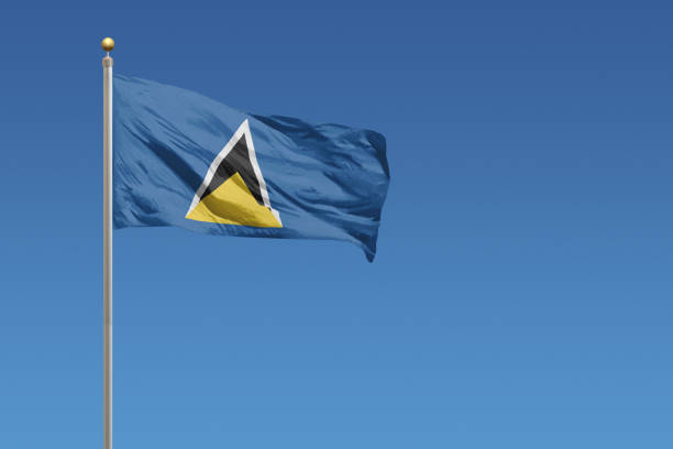 Flag of Saint Lucia in front of a clear blue sky