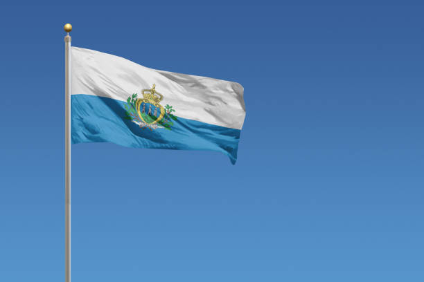 Flag of San Marino in front of a clear blue sky