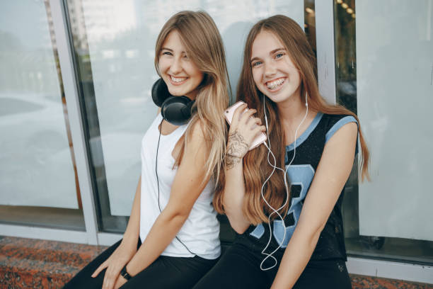istock girls with headphone 682786006