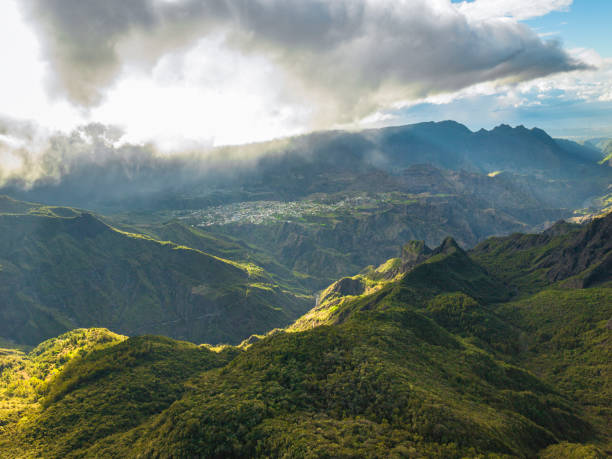 The mountain valley of Reunion Island The unbelievable and unique expanses of the island of Reunion can be seen from a bird's eye view. Beautiful tropical forests, plains and hills, as well as the famous mountain ranges, volcanoes and the embankment of the Indian Ocean. cirque de soleil stock pictures, royalty-free photos & images