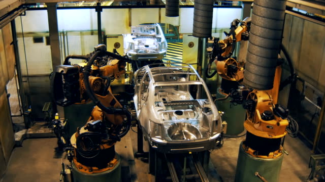 robots are welding the car body, making car body on a automobile factory