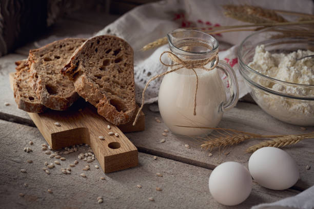istock Fresh dairy products: milk, cottage cheese, multigrain homemade bread, fresh eggs and wheat on rustic wooden background. 682800986