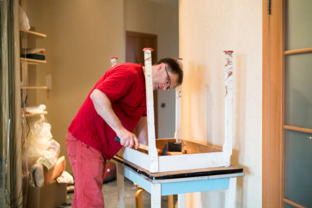 istock Mature man repairing the old kitchen table 682817694