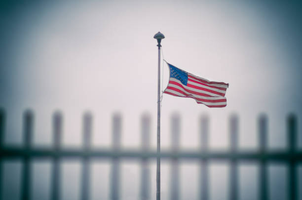 istock American Flag Flying Behind Fence 682826068