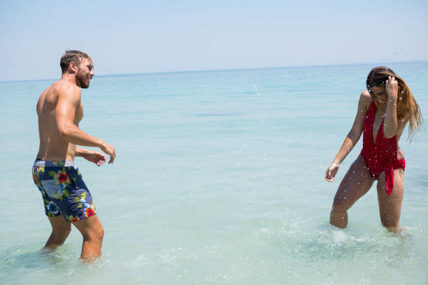 istock Playful couple enjoying in sea 682829664