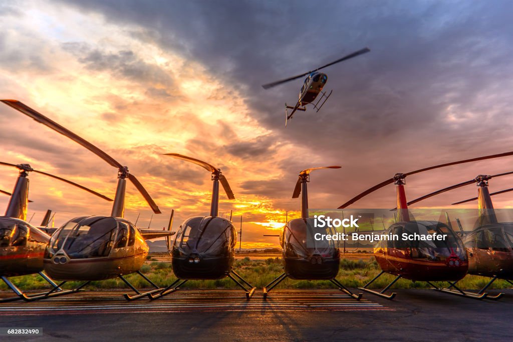 The Flyover Bell 206 overflying a line of Robinson R44 helicopters. Helicopter Stock Photo