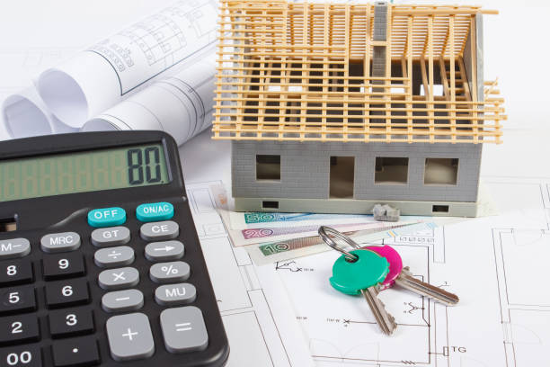 istock House under construction, keys, calculator, polish currency and electrical drawings, concept of building home 682835568