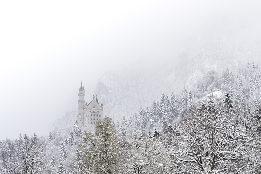 Neuschwanstein Castle in winter landscape. a nineteenth-century Romanesque Revival palace on a rugged hill above the village of Hohenschwangau near Füssen in southwest Bavaria, Germany.
