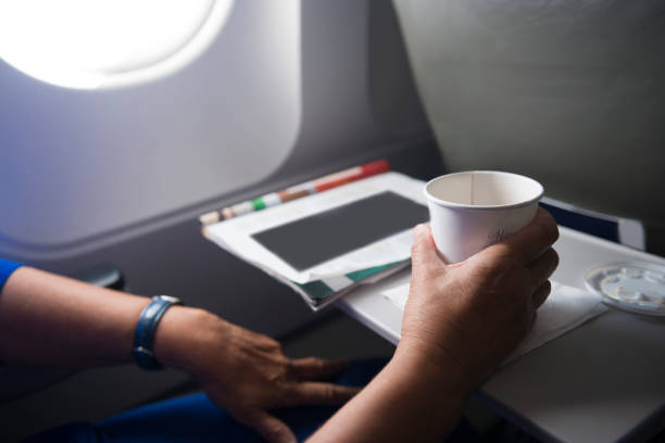istock Senior Woman Hands on Airplane Tray with Coffee Cup 682842588