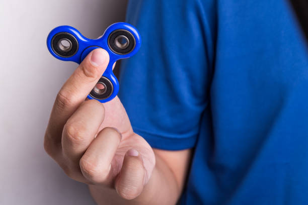 tiener houden de fidget spinner - handspinner stockfoto's en -beelden