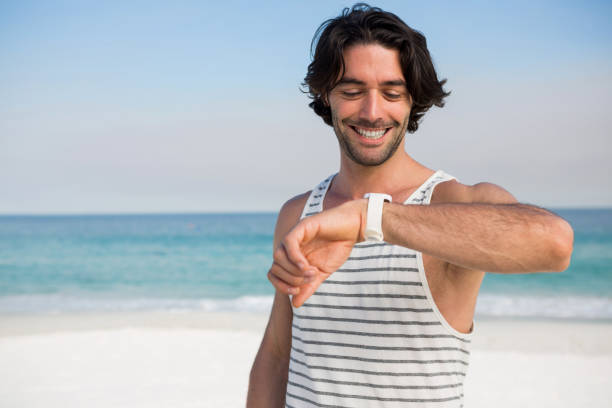 istock Smiling man looking at wristwatch 682848414