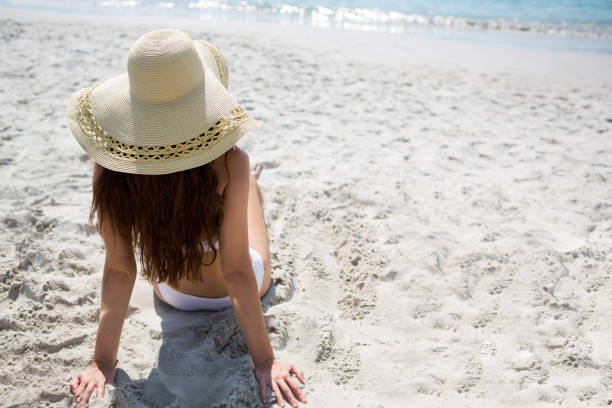 istock High angle view of woman relaxing at beach 682848816