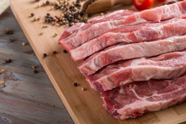 istock Few pork steaks from neck on wooden board 682869860
