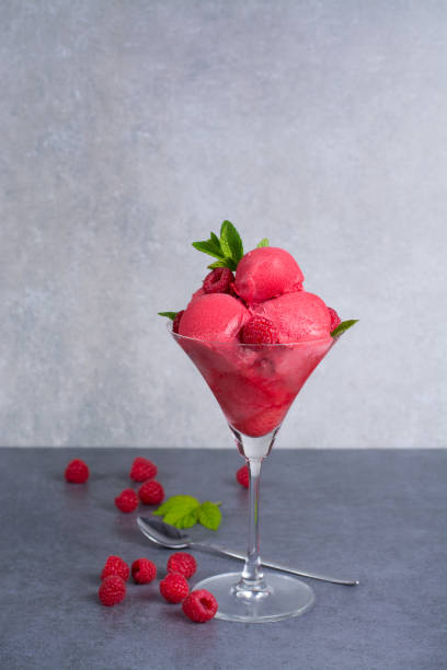 istock Raspberry ice cream sorbet in glass with raspberry, mint leaves  copy space on grey textured background 682876570