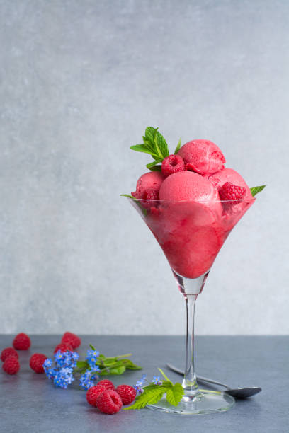 istock Raspberry ice cream sorbet in glass with raspberry, mint leaves  copy space on grey textured background 682876582