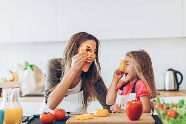 istock Mom and daughter playing with pepper slices 682879868