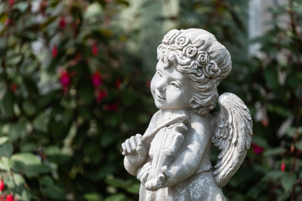 Study in DOF with foreground blurred and statue of St. Francis of Assissi in focus.