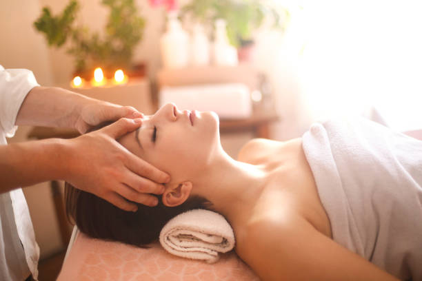 Head massage Young woman at a health spa having a head massage. About 20 years old, Caucasian female. alternative healthcare worker stock pictures, royalty-free photos & images