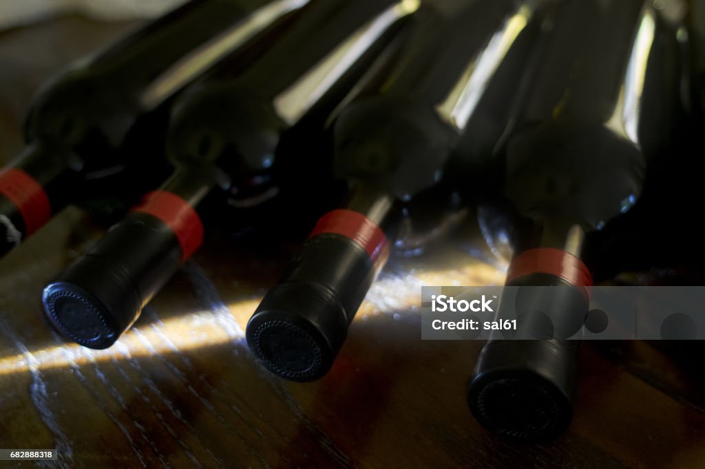 ageing of red wine ageing of red wine in a cellar with weak light and a light beam Aging Process Stock Photo