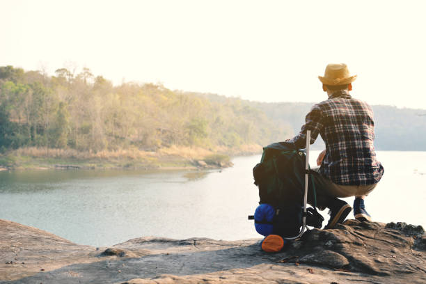 istock Happy Asian hipster man backpack in nature background 682896358