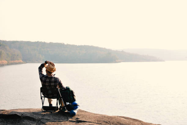 istock Happy Asian hipster man backpack in nature background 682897238