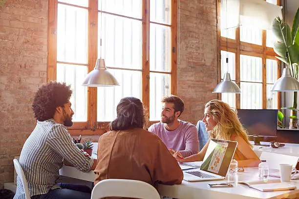 Photo of Professionals sitting at desk in office