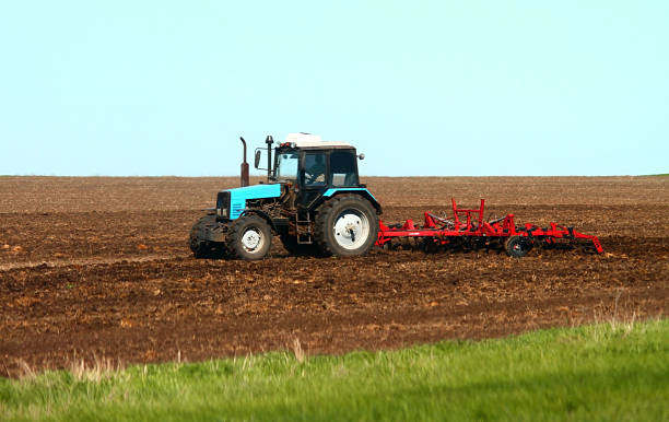 istock The plow tractor plows the field 682898394