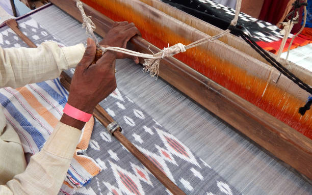 worker weaving hand loom Indian saree or sari, woman dress stock photo
