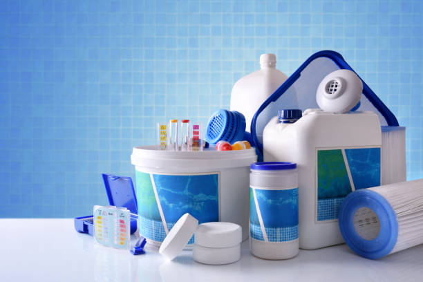 Chemical cleaning products for pool with blue mosaic background overview Chemical cleaning products for pool water on white table and blue mosaic background. Horizontal composition. Front view chlorine stock pictures, royalty-free photos & images