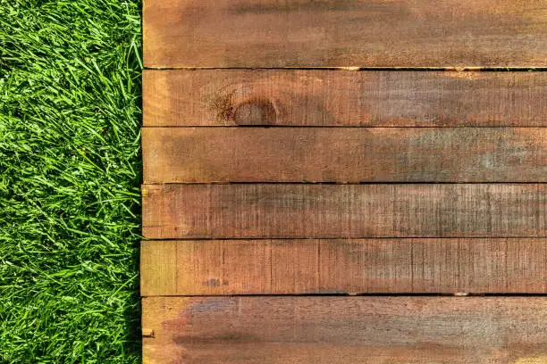 Photo of Wooden board on green grass, picnic related design template