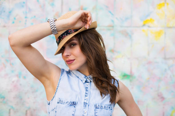 istock Pretty woman standing against bright painted wall 682919596