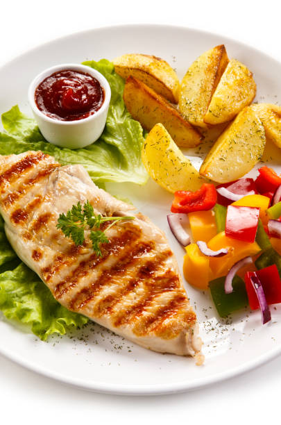 istock Grilled chicken breast with potatoes and vegetables salad 682921078