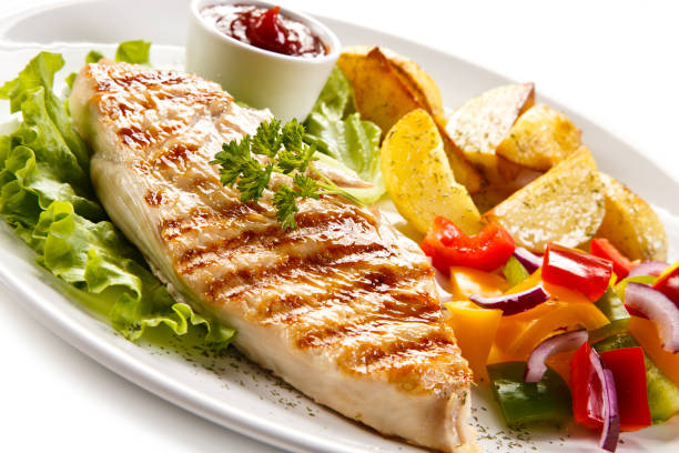 istock Grilled chicken breast with potatoes and vegetables salad 682921110