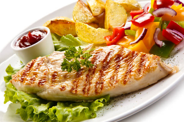 istock Grilled chicken breast with potatoes and vegetables salad 682922046