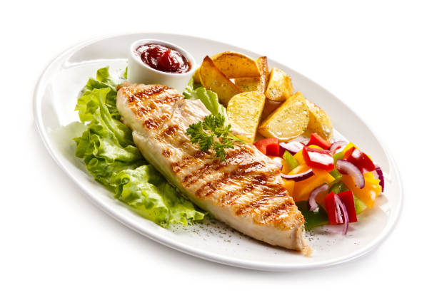 istock Grilled chicken breast with potatoes and vegetables salad 682923182