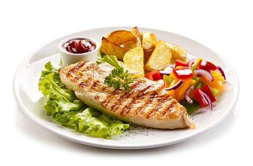 Grilled chicken fillet with potatoes and vegetables salad