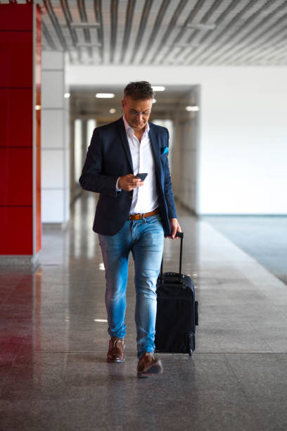 istock Businessman with a cell phone and a suitcase 682923300