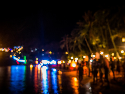 This image was taken in the early hours of New Years day, from a public beach in Koh Lanta, Krabi, Thailand.  The reflection of the party lights can be seen in the Andaman Sea and numerous unrecognisable, incidental people, have come to party.