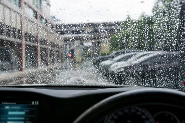 istock raindrop windshield from inside the car, at the car park. 682923928
