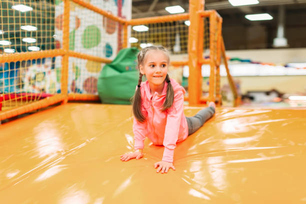 istock Cute girl having fun on inflatable attraction 682940504