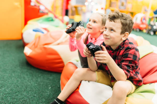 istock Kids play in a games console, happy childhood 682940606