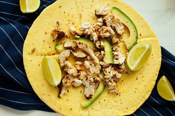 istock Tortilla with chicken, avocado and lime top view 682943244