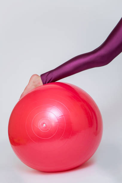 istock Young woman exercise with red pilates ball isolated on white 682943982